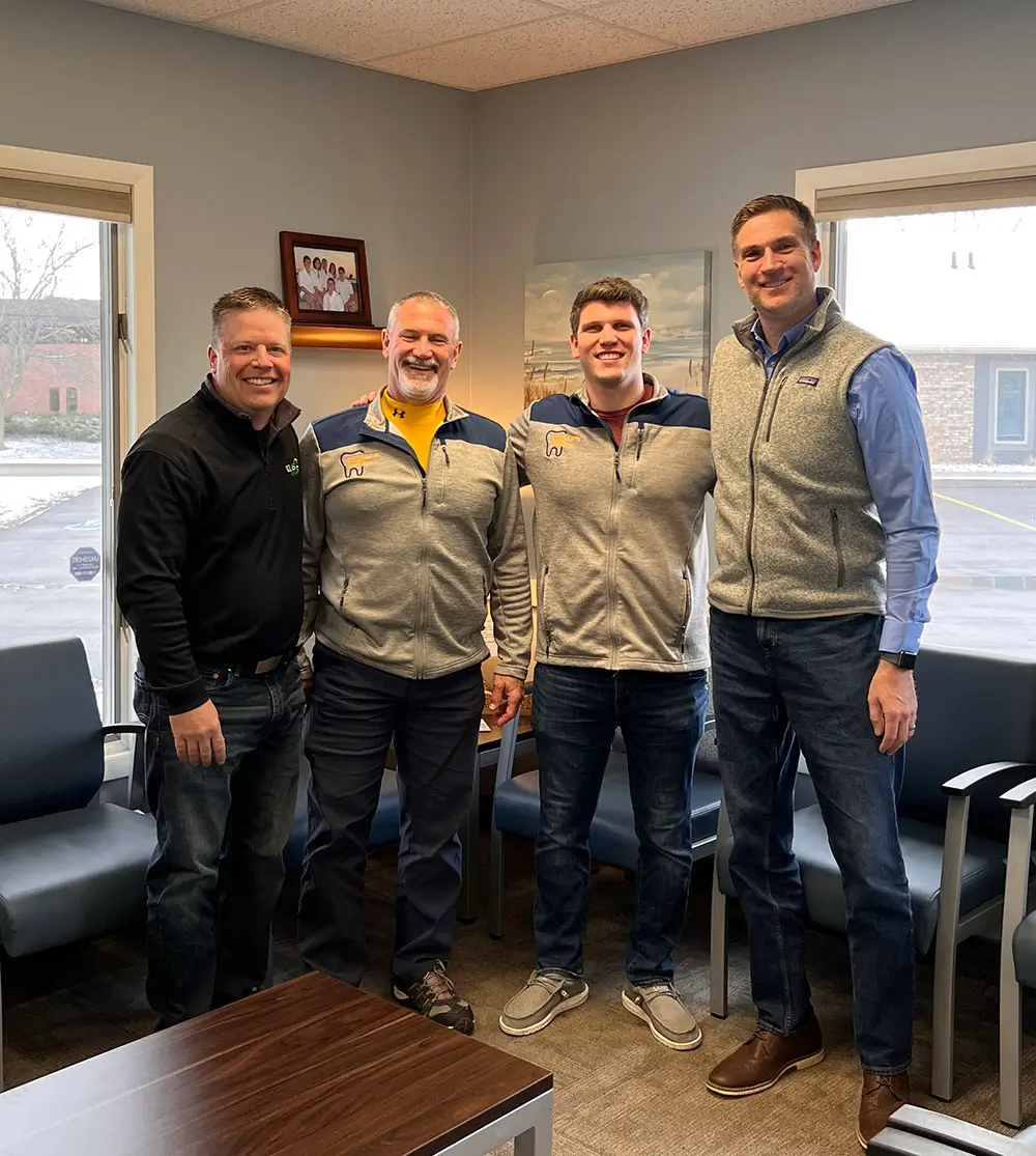 Dr. Peter Rick and Dr. Peter Rick Jr. with the KLAS team after their father-and-son practice transition