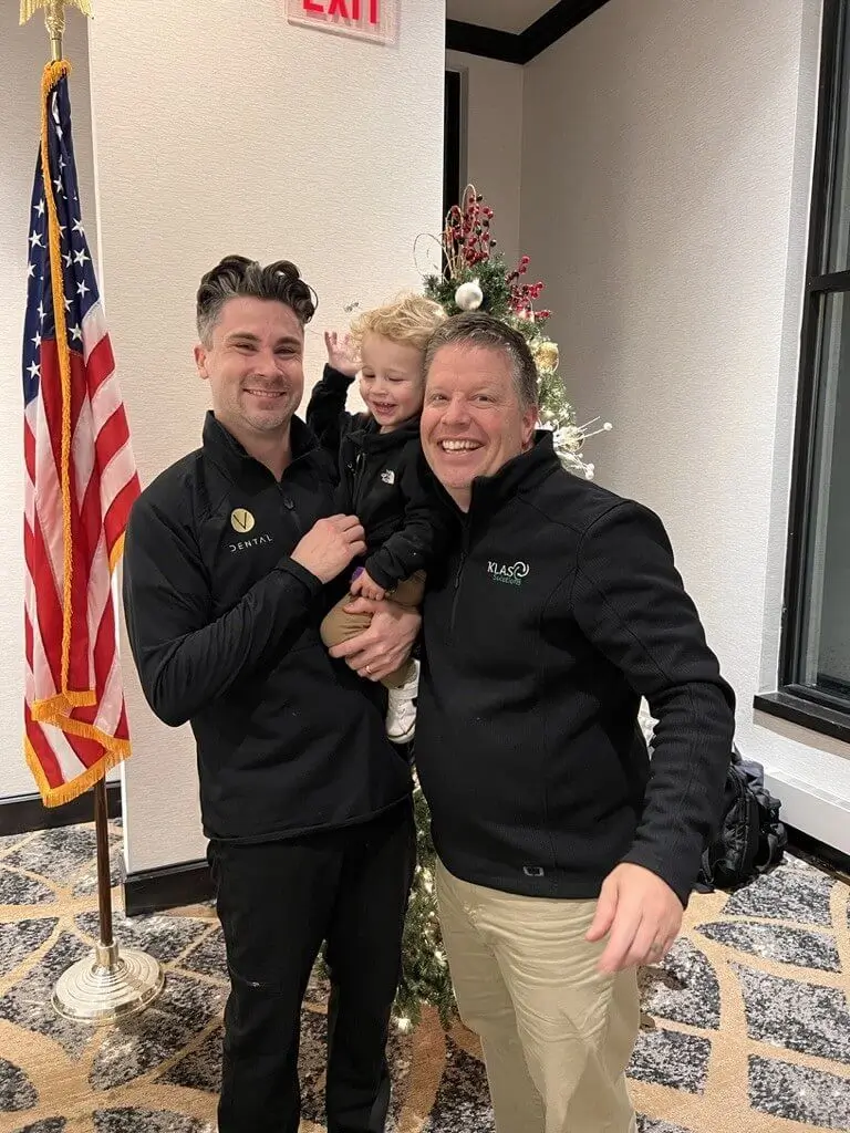 Phil Cole celebrating a completed dental practice transition with the Vander Baan family